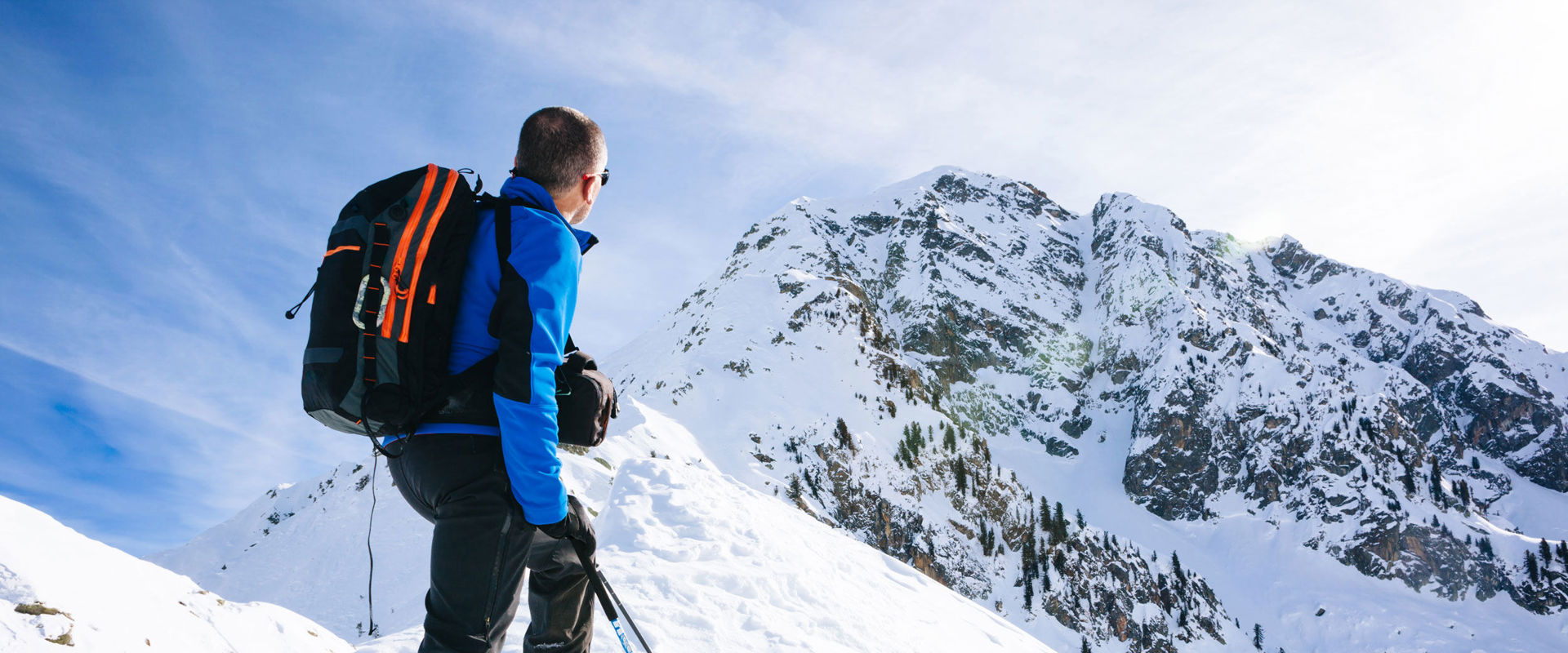 Mountain sports in winter Once arrived at the summit a skier admires the nature around him.
