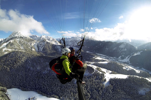 Tandem paragliding over mount Kronplatz Plan in winter.