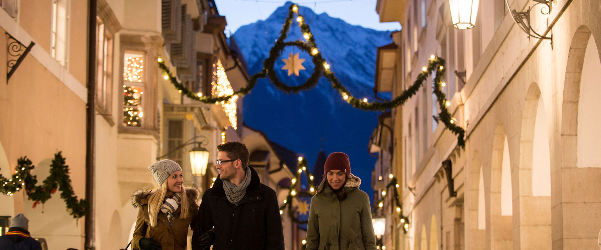 The arcades of Meran's old town centre in winter with Christmas decorations.
