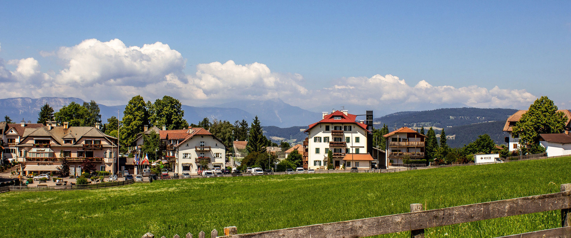 Houses and fenced meadow in Oberbozen