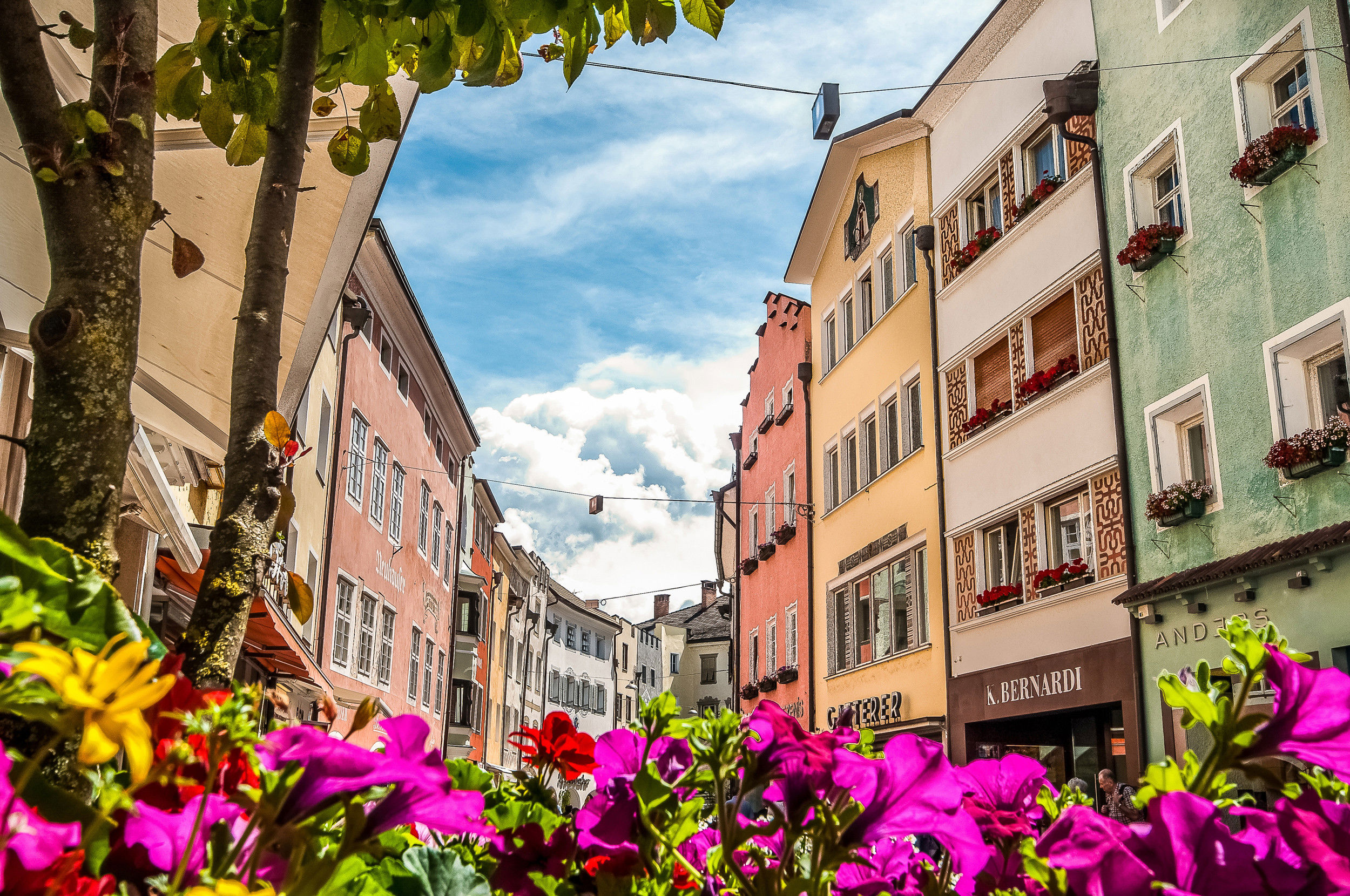 Bruneck's old town centre in summer with blooming flowers.