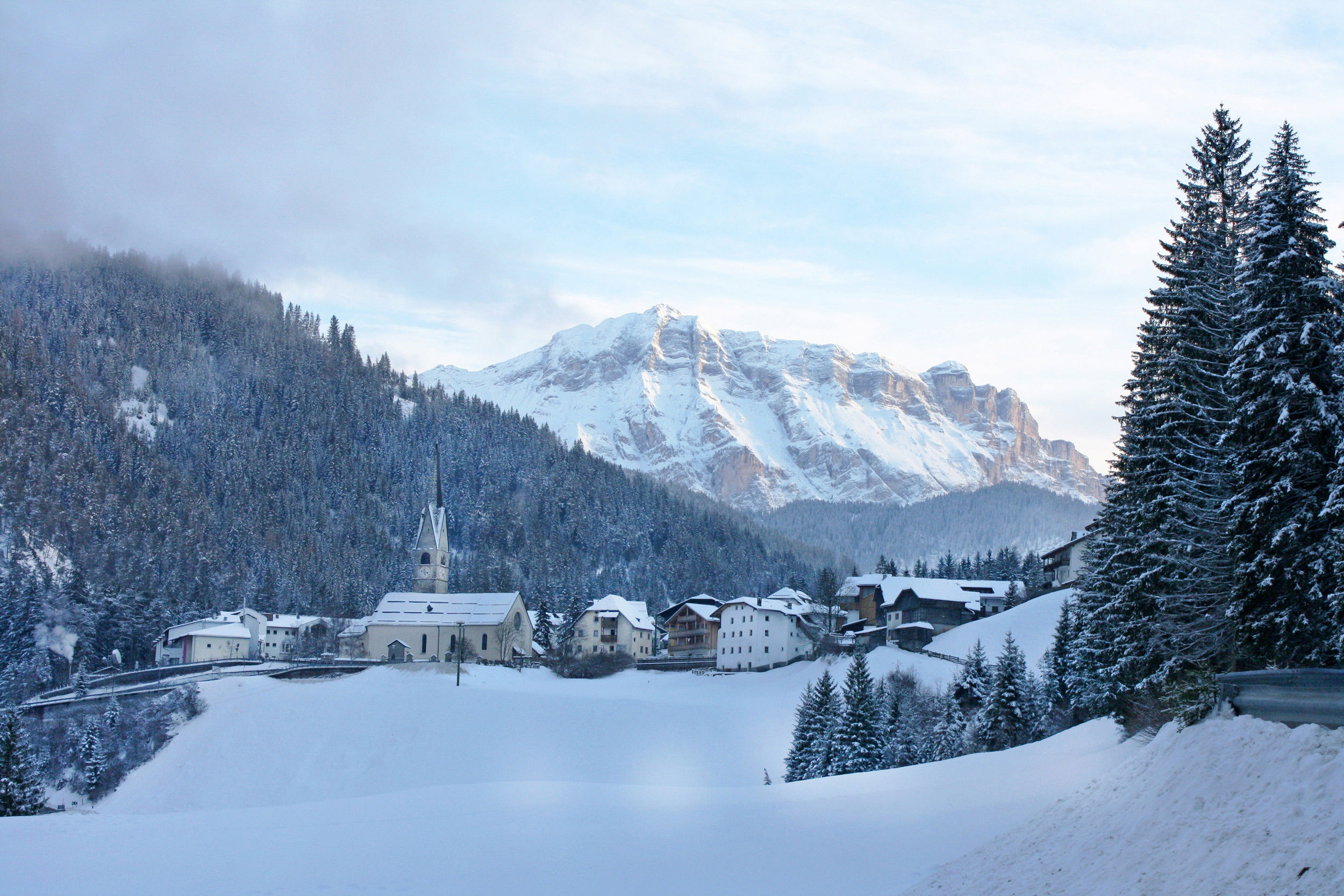St. Martin in Thurn and Mt. Heiligkreuzkofel in snowy winter landscape