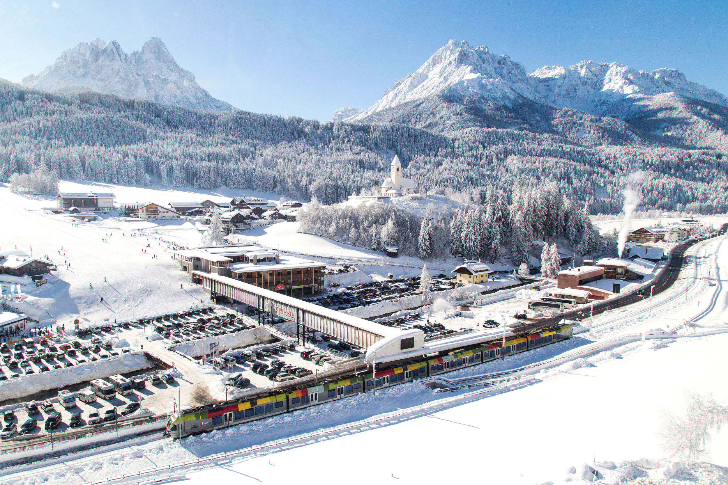 Helm car parking with ski train Pustertal & snowcovered mountain landscape