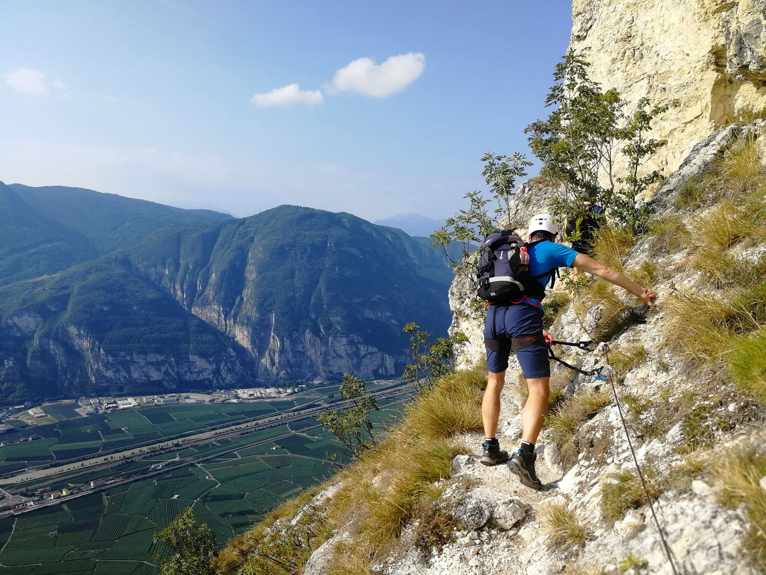 Man walks the via ferrata Fennberg with a marvellous view of the Unterland.