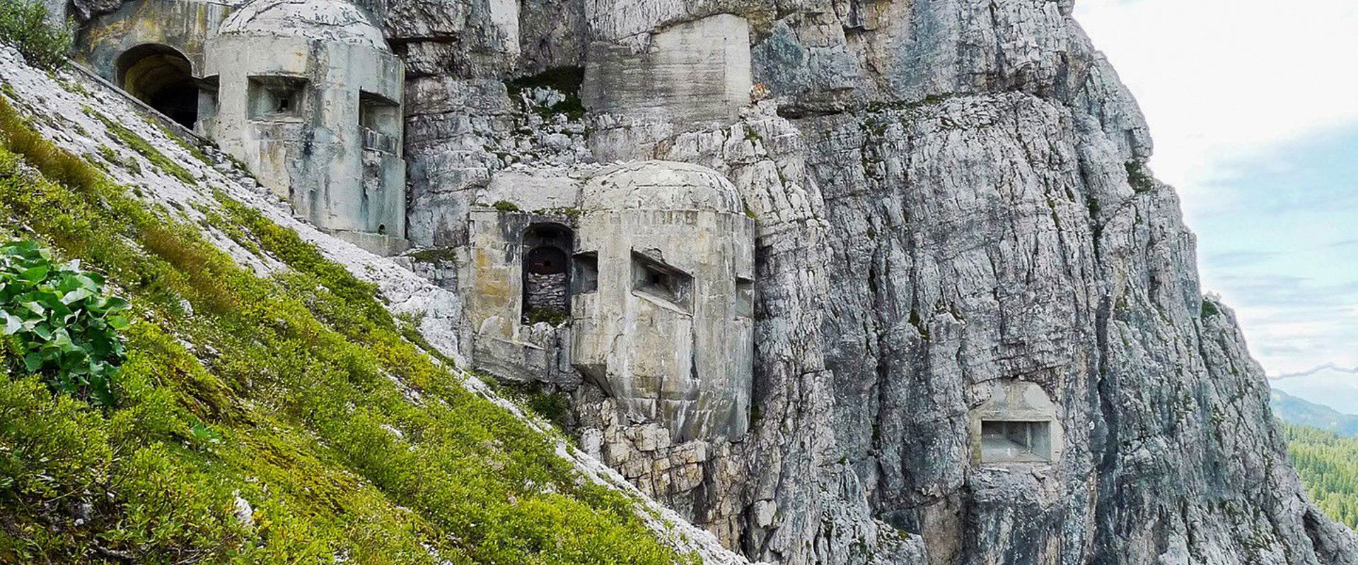 Bunkers are camouflaged in the steep rock faces.