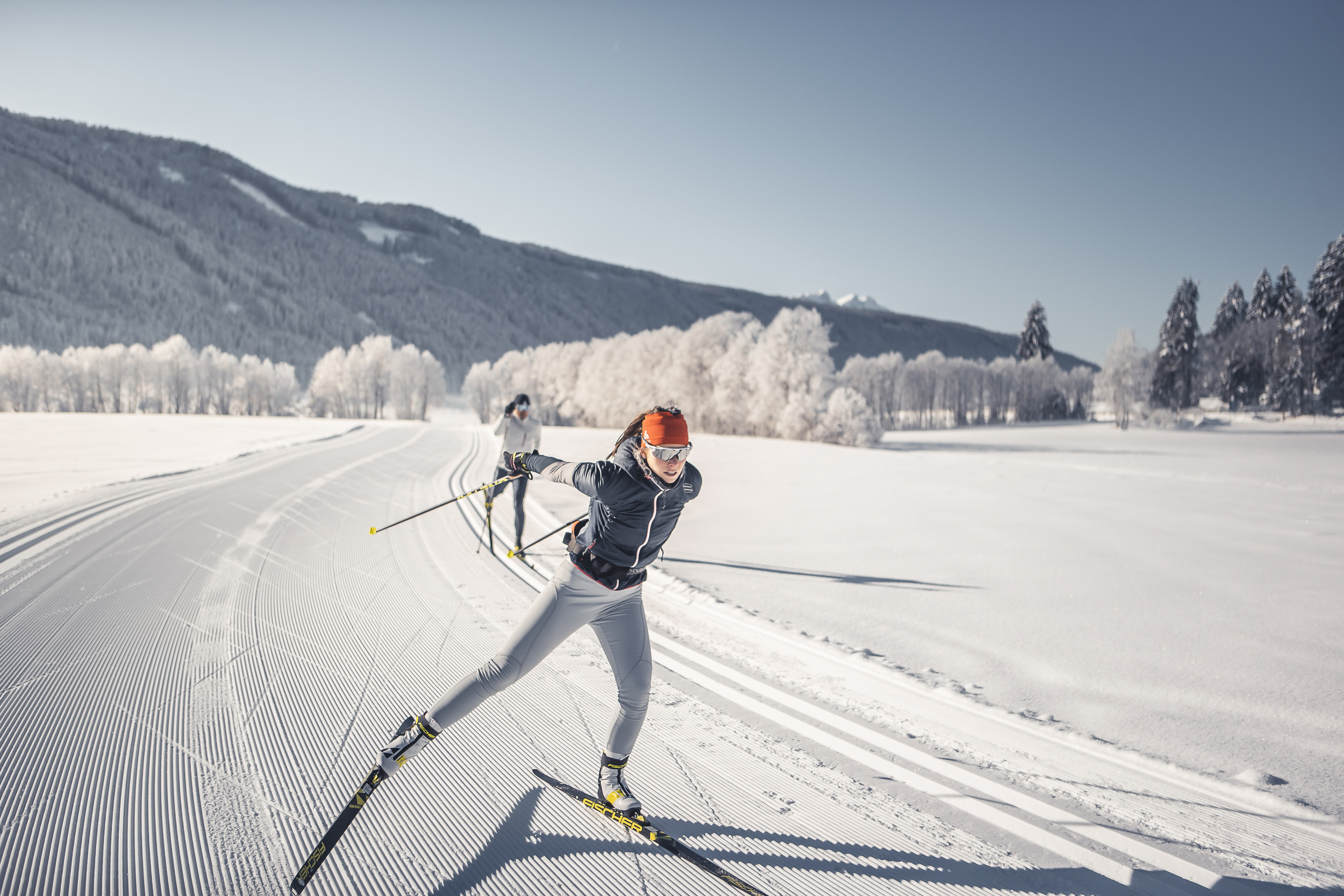 Snowy landscape in Gsies Valley with cross-country skiers