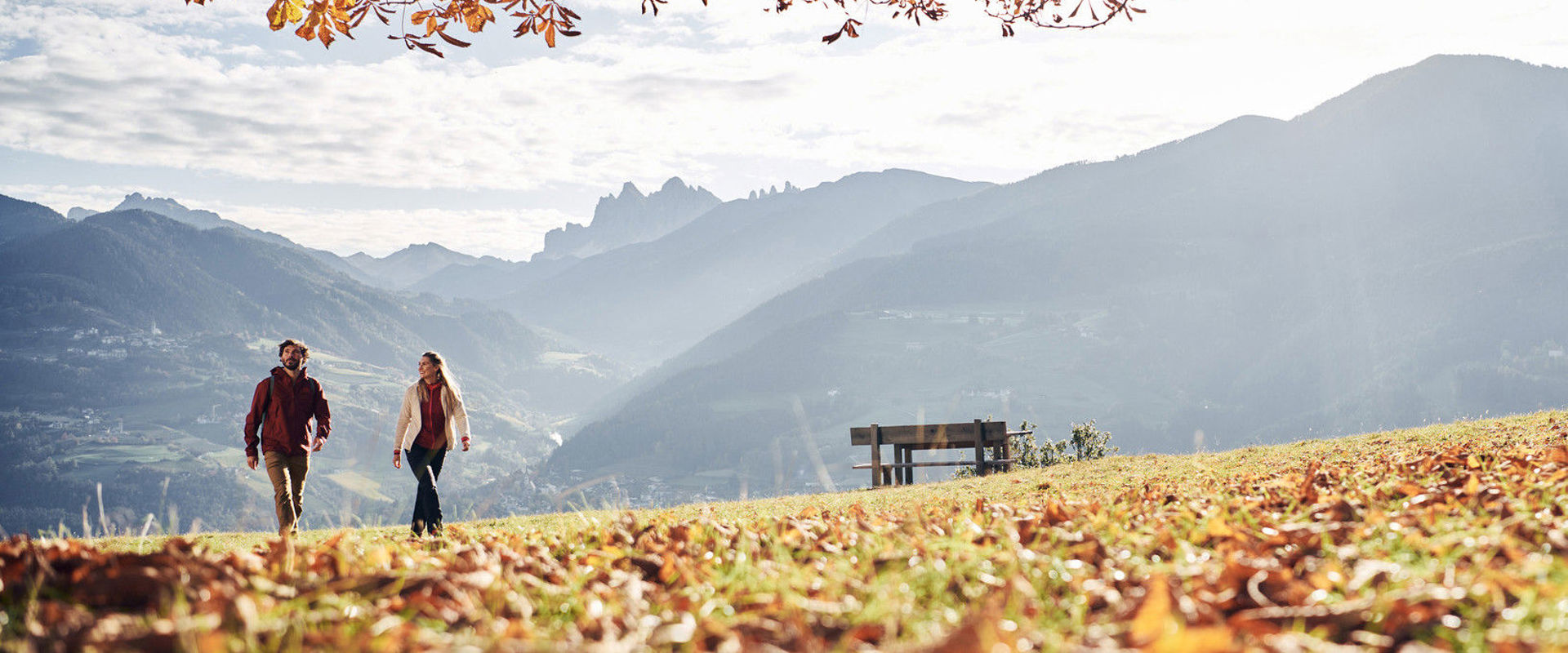 Autumn atmosphere on the mountain Man and woman take a walk in the autumn landscape.