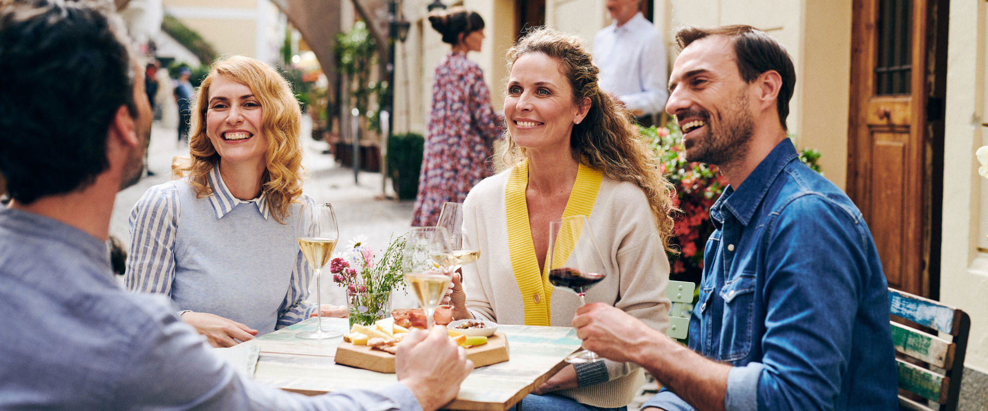 Apéritif Friends sit outside and enjoy an apéritif.
