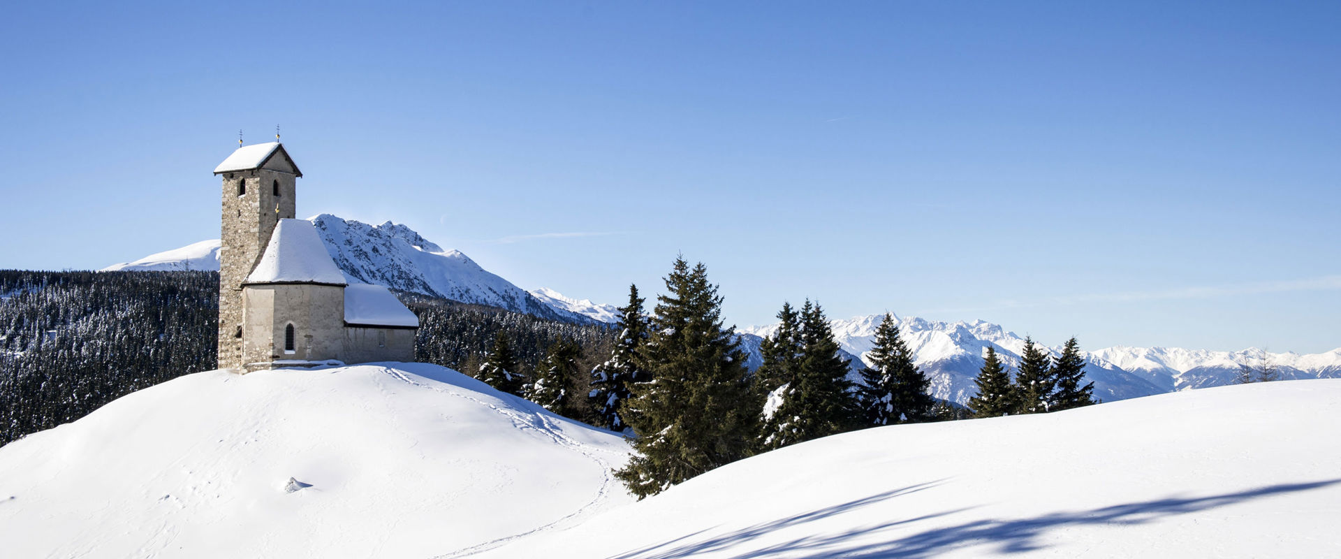 Vigiljoch St. Vigilius church near Lana in a dreamlike snow landscape