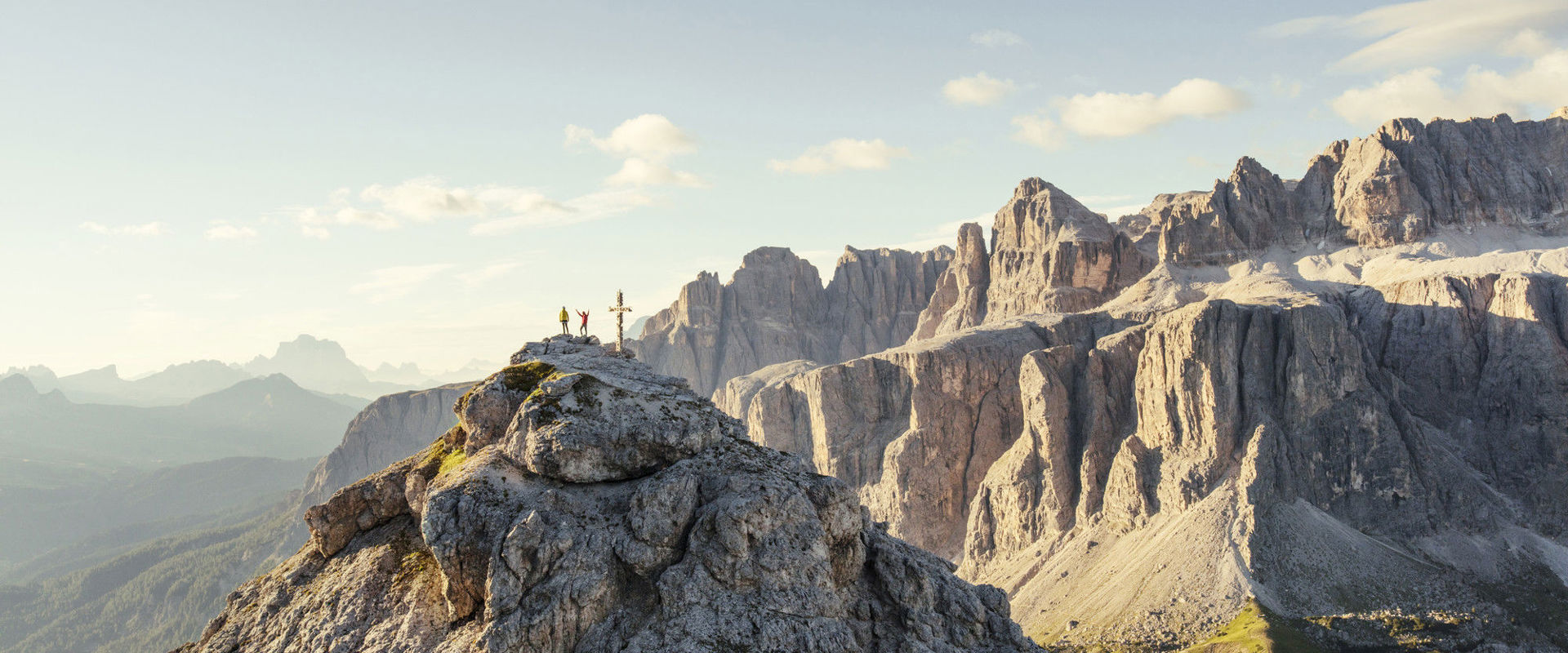 Hikers on top of Mt. Große Cirspitze, with the Sella massif in the background