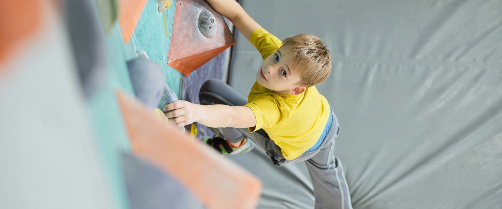 Child climbing in an indoor climbing hall