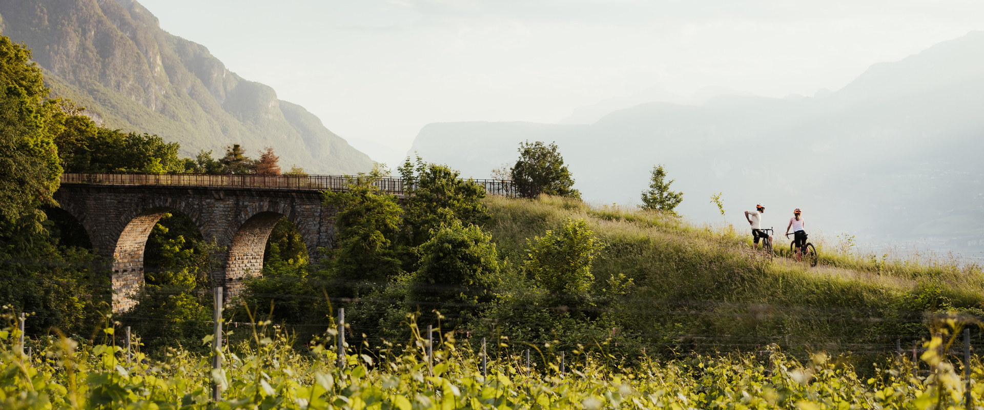 Cyclist just near a historic bridge in the middle of the countryside