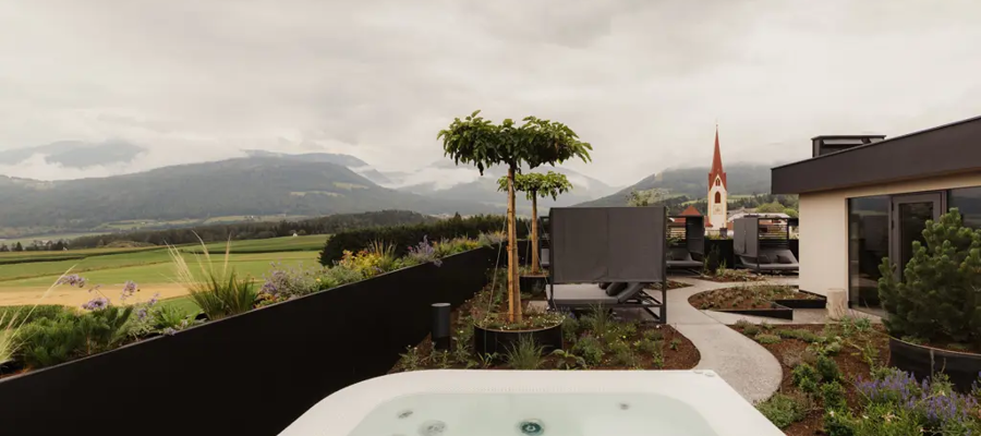 Rooftop hot tub at a new hotel with a church in the background